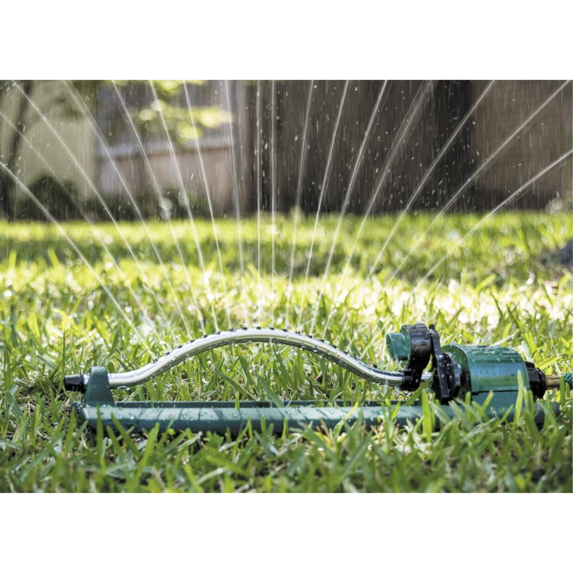 Sprinkler watering a grassy area with water spraying out